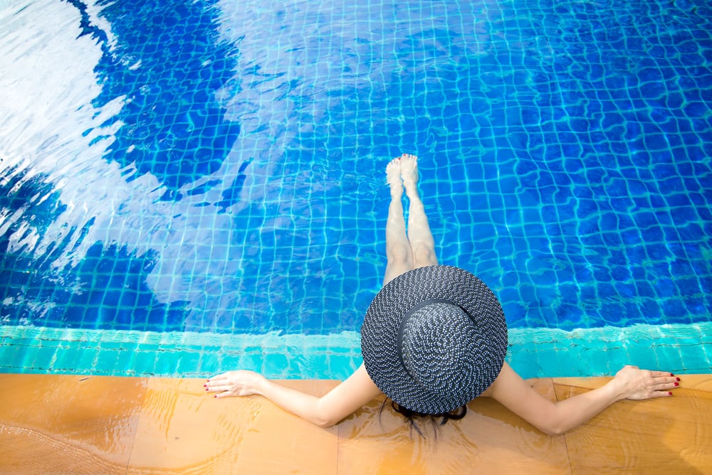 Woman lounging in heated swimming pool