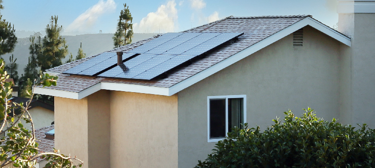 Nine solar panels on asphalt shingle roof of a two story home.