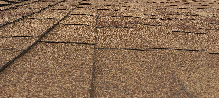 Close up of brown, asphalt shingles installed on roof.