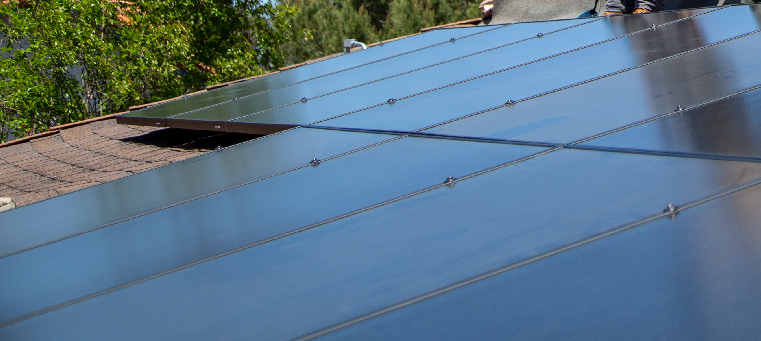 Ten solar panels installed on an asphalt-shingle roof.