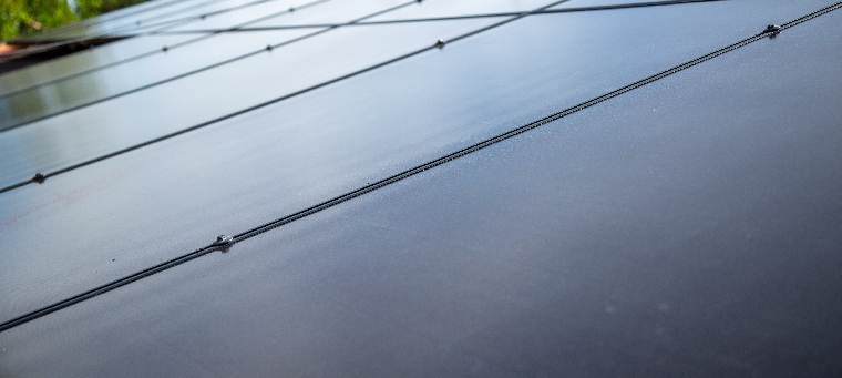 Close up of installed solar panels on roof.