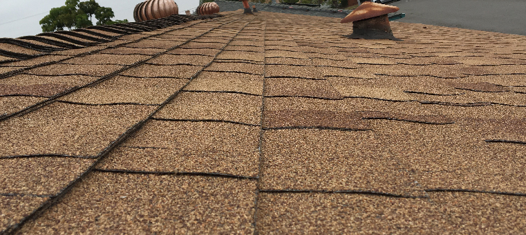 New asphalt shingles installed on roof with vents.
