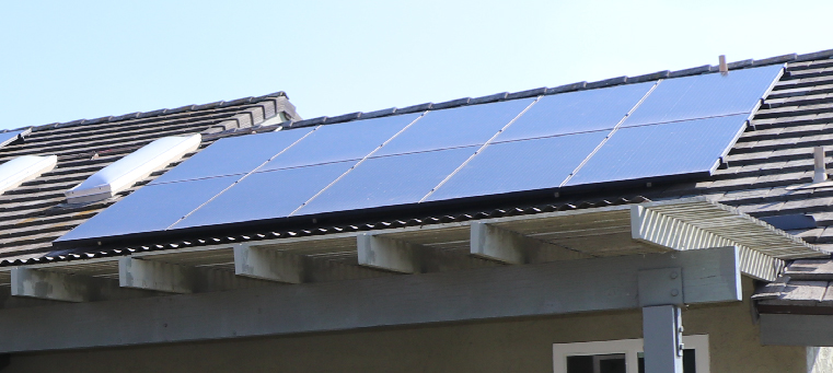 Ten solar panels on single-family home with a white pergola.