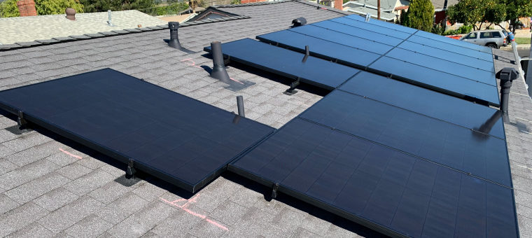 Solar panels on asphalt shingle roof.