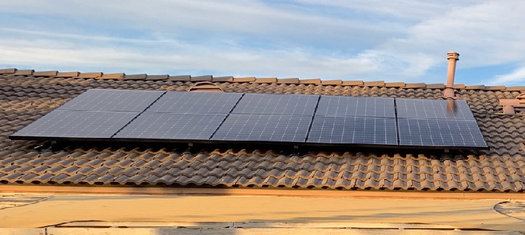 Ten solar panels on clay tile roof.