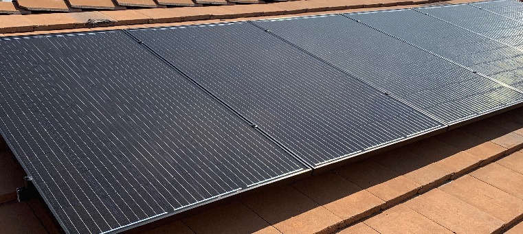 Six solar panels on home with a tile roof.