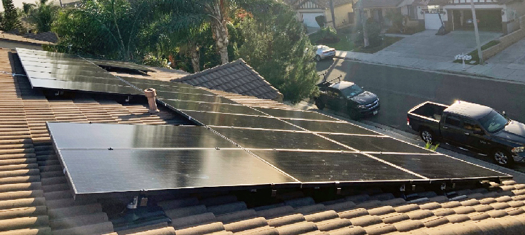 twenty-two solar panels on two story single family home with clay tiles.